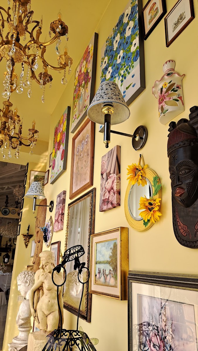 A wall covered in mismatched antique plates and framed pictures