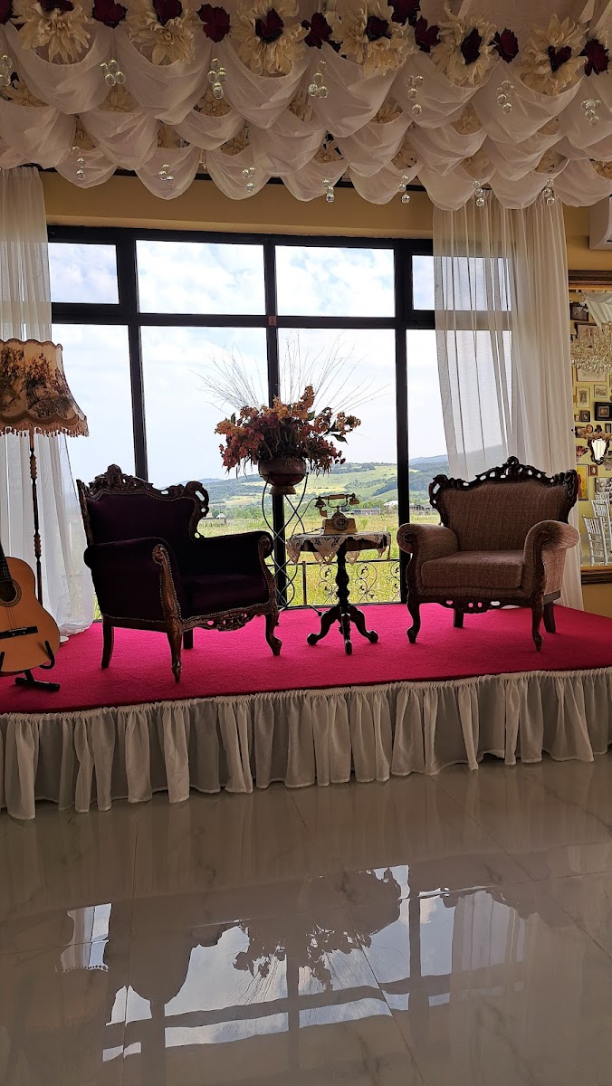 Armchairs by the tall window, the hills of Tianeti beyond