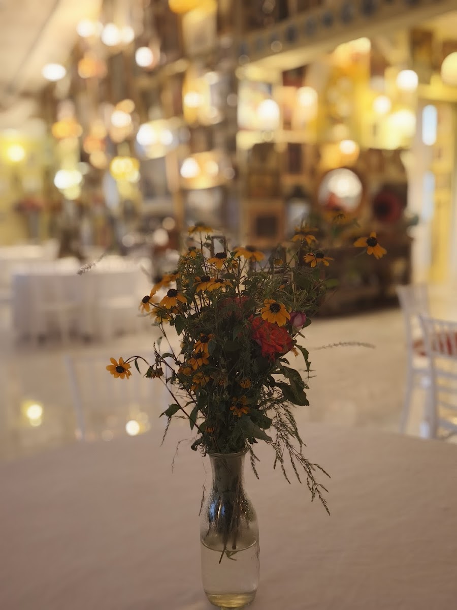 Wildflowers on a table in the lamplit dining room