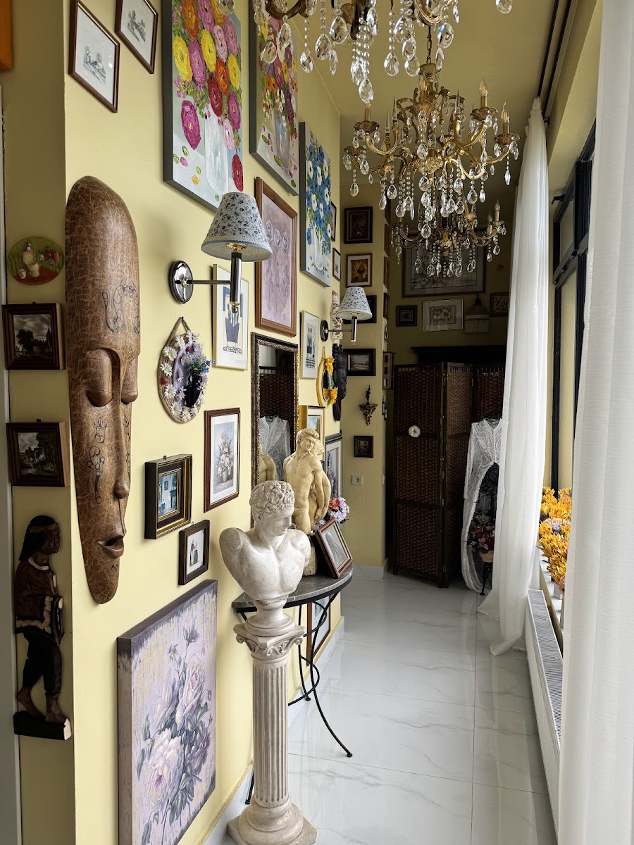A hallway of pictures, masks and sculpture