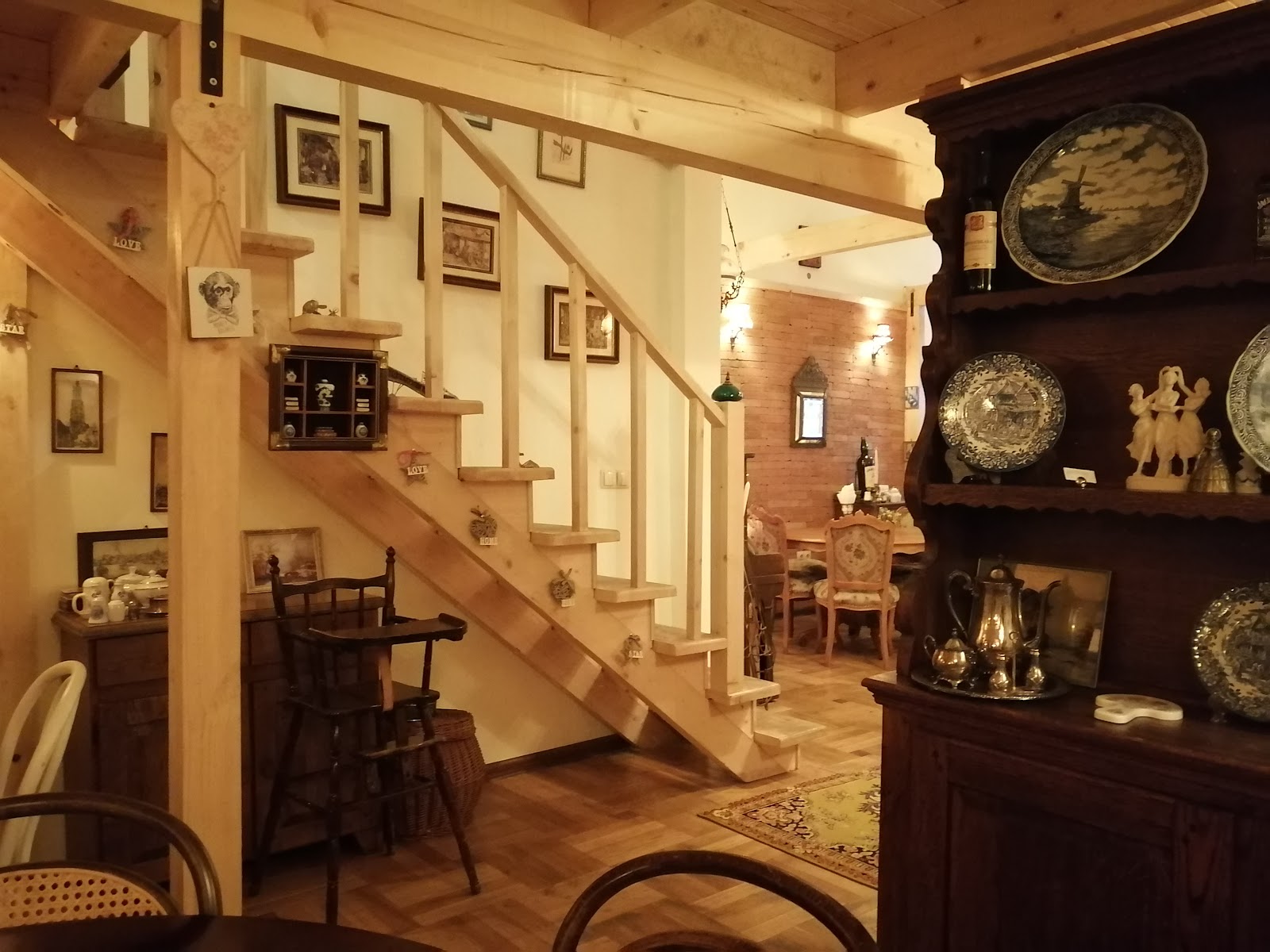 The wooden staircase and a dresser of collected silver